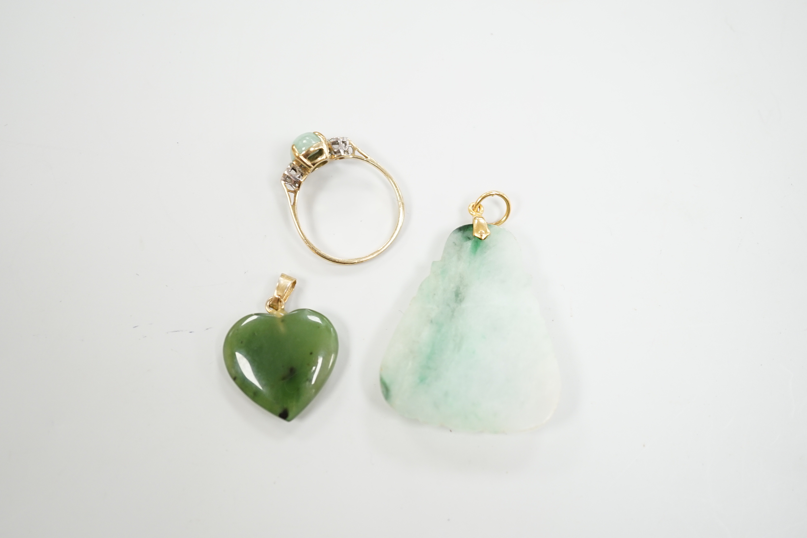 Two mounted jade pendants, including heart shaped nephrite and a 9ct gold, simulated jade and diamond chip set ring.